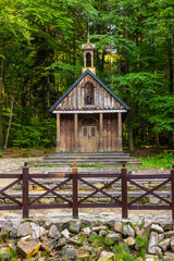Traditional forest shrine of St. Francis in Swieta Katarzyna village near Bodzentyn at tourist path to Lysica peak in Swietokrzyskie Mountains in Poland - obrazy, fototapety, plakaty