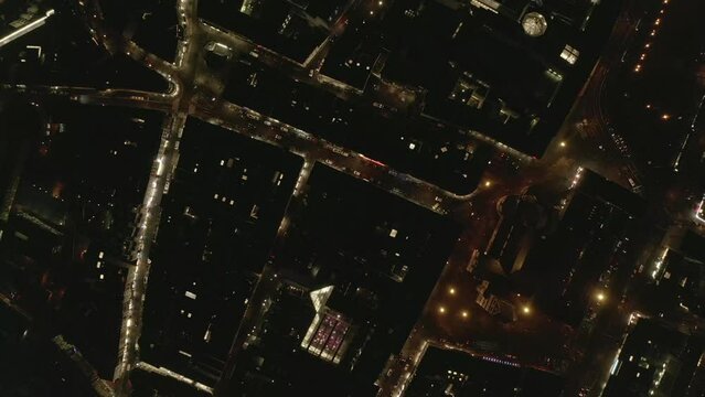 Top down panning footage of town development and illuminated streets in night city. Cologne, Germany