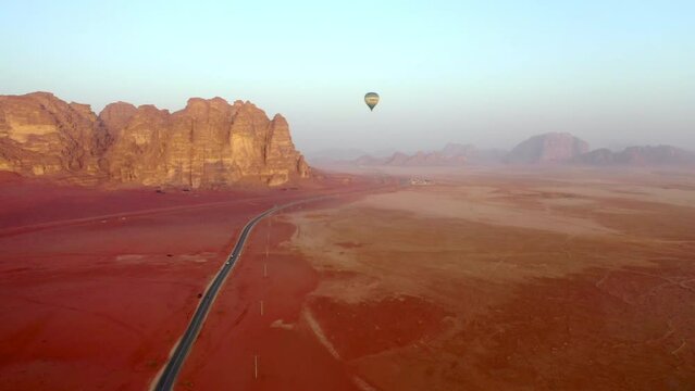 Aerial Forward Shot Of Hot Air Balloon Flying At Wadi Rum Desert
