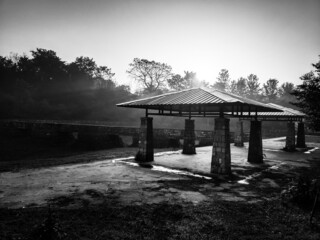A monochromatic shot of a gazebo or garden shed in the morning with mist. Uttarakhand India.