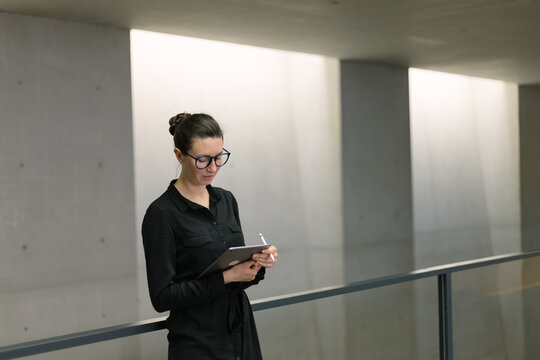 Woman working using tablet pc in minimalist office workspace
