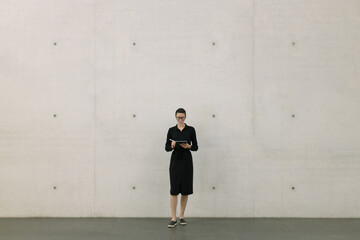 Obraz na płótnie Canvas Business woman using tablet pc in minimalist office interior