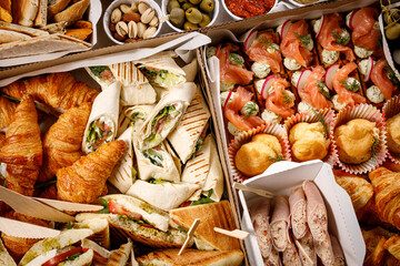 Snacks box with sandwiches and croissant.