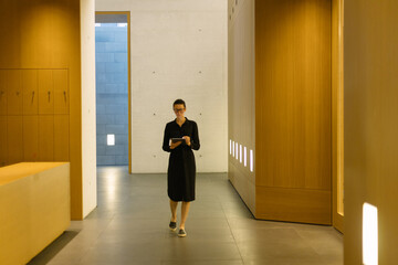 Business woman using tablet pc in minimalist office interior