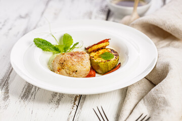 Delicious and healthy homemade food. Turkey cutlets and grilled vegetables. Cheese sauce with garlic and olive oil. Food composition on white wooden background. Close-up. Copy space