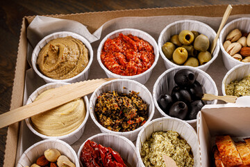 Set of sauces, appetizers, vegetables and hummus.