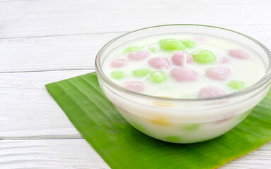 Thai dessert with colorful flour, milk, egg, rainbow colored tapioca Famous Thai dessert, Bualoy on a wooden table, top view.
