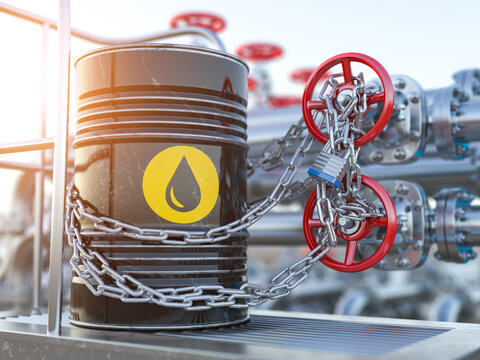 Oil crisis concept. Oil barrel and oil pipe line locked with chain.