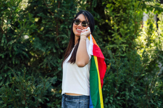 Young Asian woman holding rainbow flag