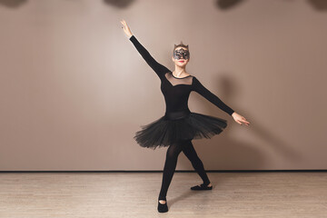 graceful ballerina in black swan dress. Young ballet dancer practicing before performance in black tutu, classical dance studio, copy space