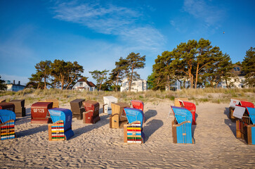 Strandkorb providing shelter from sun and wind. Hooded Wicker beach chairs on a beach at the baltic...