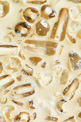 Cold coffee and ice cubes,Coffee texture and macro ice cubes,Close-up of Cold latte drink with ice cubes