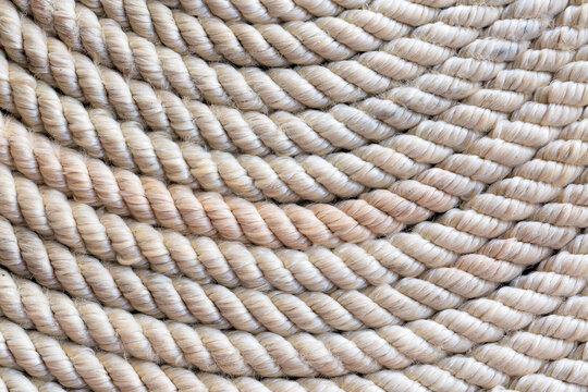 macro rope texture,Super close up of a thick rope in shape of a spiral,Photo of an old vintage rope. Natural warm light