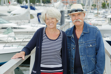 senior couple on the port - obrazy, fototapety, plakaty
