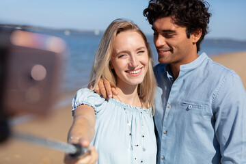 two lovers making a selfie photo near beach