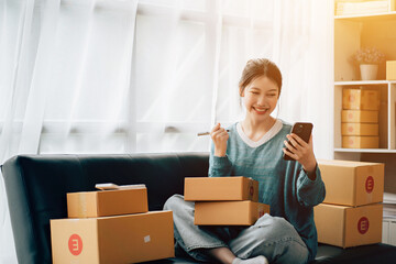 Fototapeta na wymiar Asian teenager owner business woman work at home for online shopping and sale.