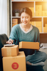 Asian teenager owner business woman work at home for online shopping and sale.