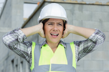 woman contractor worker with noise cancelling headphones