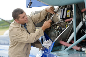 man working on an aircraft using a spanner
