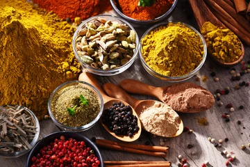 Rolgordijnen Variety of spices on kitchen table © monticellllo