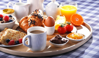 Breakfast served with coffee, juice, croissants and fruits