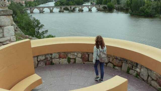 Woman looking out over a viewpoint facing the Zamora River in the beautiful city of the same name, Spain.