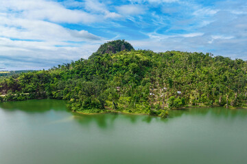 Ilijan Hill, as seen from a reservoir lake in Tubigon, Bohol, Philippines.