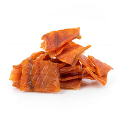 Pieces of salted dried fish with spices on a white background, an appetizer for beer.