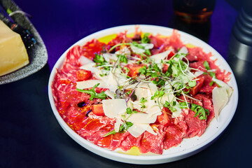 Carpaccio with arugula and parmesan in the restaurant