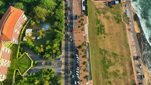 Aerial Top Forward Shot Of Cars Moving On Road By Sea In City - Colombo, Sri Lanka