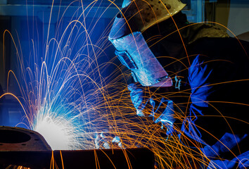 The welder is welding steel plates