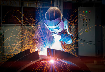 The welder is welding steel plates