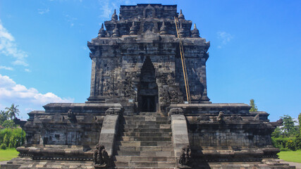 The exoticism of Mendut Temple in Indonesia with a beautiful blue sky background, is a Buddhist...