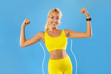 Young blonde woman in sportswear showing biceps muscles, keeping slimming diet, doing sports for...