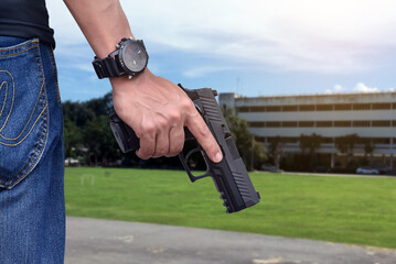 9mm automatic pistol holding in right hand of shooter, concept for security, robbery, bodyguard,...