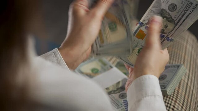 Hands counting US Dollar bills or paying in cash. Concept of investment, success, financial prospects or career advancement