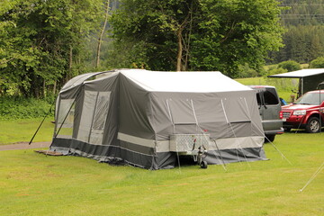 an old folding caravan on a campsite