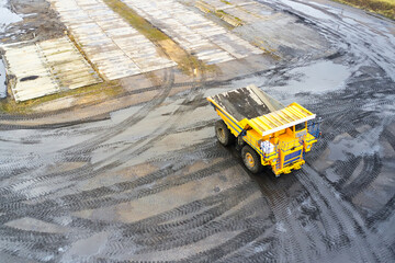 Top view of a yellow mining dump truck during mining operations © korsarid