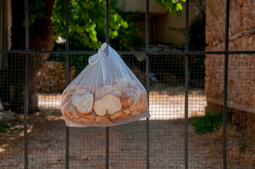 A bag of sliced bread hung over the garden gate.