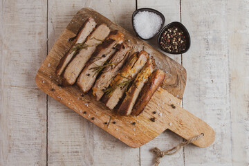 Roasted pork, slices pork meat on cutting board piece 