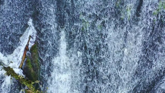 waterfall with a fallen trunk in Ega river. Drone view. 4K. Iguzquiza, Navarre, Spain, Europe.