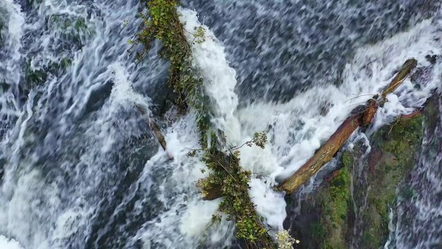 waterfall with a fallen trunk in Ega river. Drone view. 4K. Iguzquiza, Navarre, Spain, Europe.