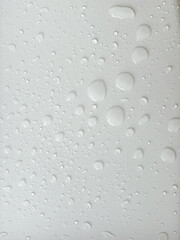 Water droplets on a white background. For background about drizzling rain with natural drops. 