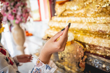 Beautiful Asian girl at big Buddhist temple dressed in traditional costume