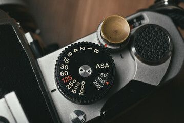 Vintage film camera, Old SLR 35mm manual camera close up on speed shutter dial.