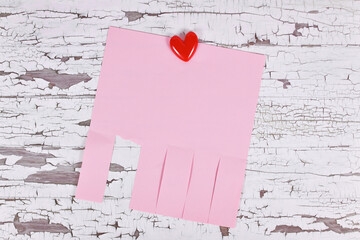 Pink empty tear-off stub paper note without text with heart shaped pin