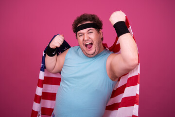 Young attractive guy with a flag posing in the studio.	