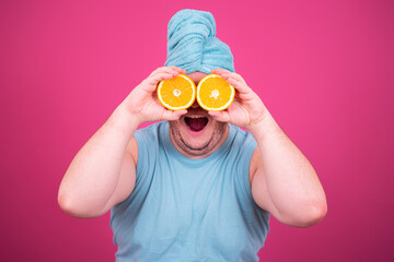 Fruit oranges. Funny fat man on a pink background. Retro style.