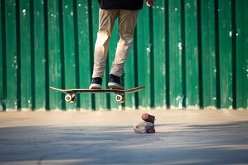 Skateboarder jumping obstacles made of bricks and stones