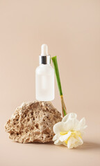 Obraz na płótnie Canvas Cosmetic serum bottle on travertine stone podium. Minimal mockup background.